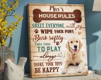 May include: A wooden sign with the text "Max's House Rules" and a list of rules for dogs, including "Greet everyone with joy", "Wipe your paws", "Bark softly", "Take time to play always", "Share your toys", and "Be happy". A golden retriever dog is lying down in front of the sign.