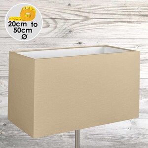 May include: A rectangular beige lampshade with a smooth fabric texture and a white interior lining. A circular graphic in the corner displays a yellow measuring tape and the text 20cm to 50cm, indicating the available diameter range.