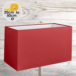 May include: A rectangular lampshade in a solid red fabric with a white interior lining. The lampshade is shown with a circular graphic indicating a diameter range of 20 cm to 50 cm. The shade features a clean, structured design with visible fabric texture.