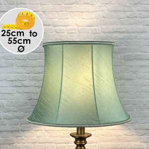 May include: A light green lampshade with a white trim. The lampshade is 25cm to 55cm in diameter.