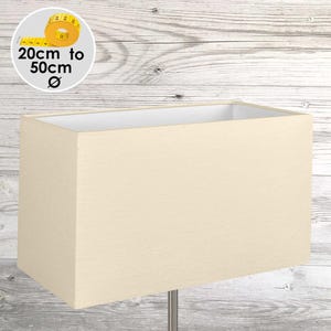 May include: A rectangular cream-coloured fabric lampshade with a smooth texture. A circular graphic in the upper left corner displays a yellow measuring tape and the text 20cm to 50cm Ø, indicating the available diameter range for this product.