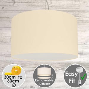 May include: Cream-coloured drum pendant lampshade. The cylindrical shade has a white interior. Diameter is 30cm to 60cm. Features a removable diffuser and easy fit design. The light hangs from a silver cord.