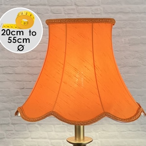 May include: A bell-shaped orange lampshade with a textured fabric finish and a scalloped bottom edge trimmed with matching orange braided cord. A circular graphic shows a yellow measuring tape with text indicating a diameter of 20cm to 55cm.
