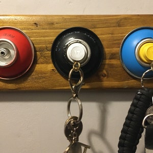 Handmade wall mounted rustic graffiti spray paint can key tidy X3 key slots. Made from empty spray paint cans and reclaimed wood.