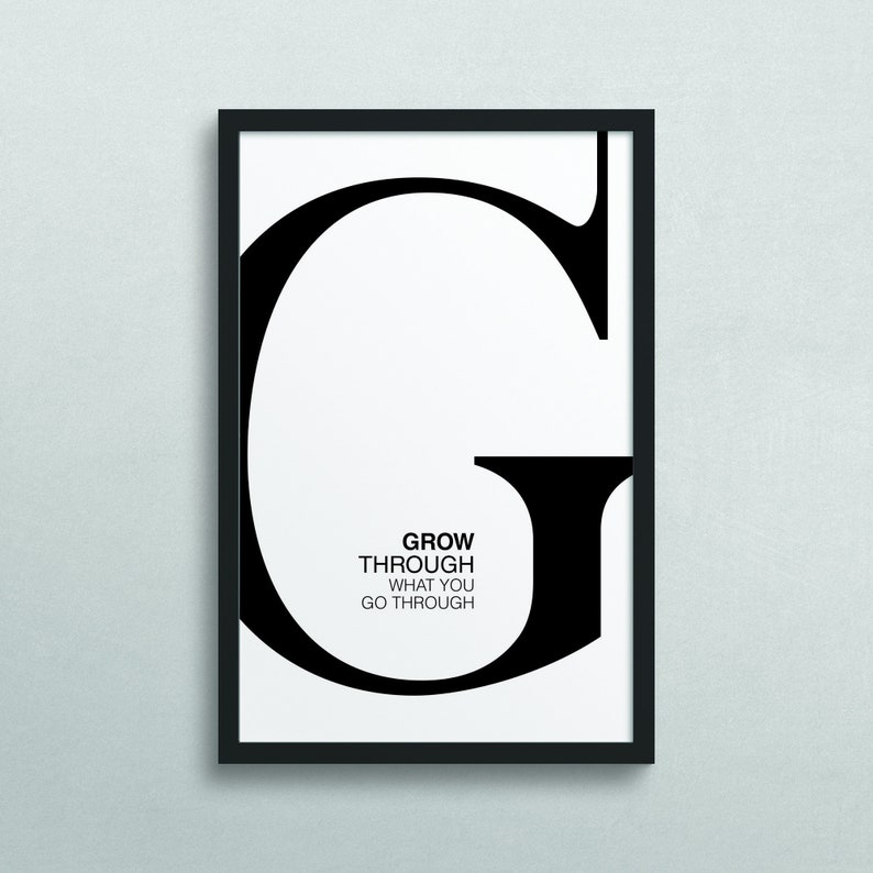 May include: Black and white framed print with a large letter G and the text "GROW THROUGH WHAT YOU GO THROUGH".