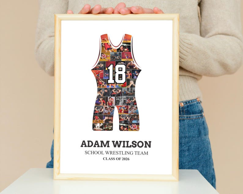 K&ouml;nnte beinhalten: Gerahmter Druck mit einem Wrestling-Singlet-Design, gef&uuml;llt mit Actionfotos. Das Singlet ist rot und schwarz mit der Nummer 18 in Wei&szlig;. Der Druck enth&auml;lt den Namen "ADAM WILSON", "SCHOOL WRESTLING TEAM" und "CLASS OF 2026".