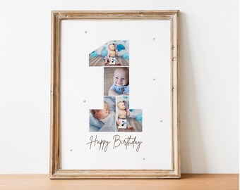 May include: A framed photo collage of a baby boy in different poses, forming the number one. The collage is on a white background with blue hearts scattered around the number. The text "Happy Birthday" is written in brown cursive below the number.