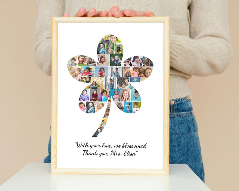 May include: A framed photo collage in a light wood frame. The collage is in the shape of a four-leaf clover and is filled with multiple small photos. The text at the bottom reads, "With your love, we blossomed. Thank you, Mrs. Elisa."