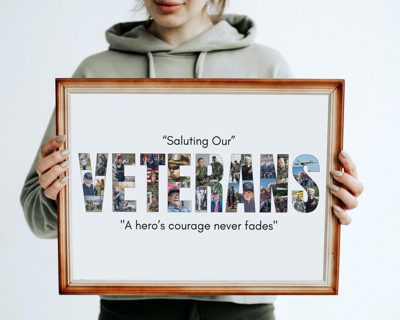 May include: A framed print with a brown wooden frame. The word "VETERANS" is spelled out in large letters, each filled with a collage of photos. The text "Saluting Our" and "A hero's courage never fades" are above and below the word.