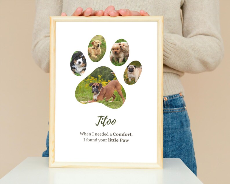 May include: A framed print featuring a paw print design with images of dogs inside. The print includes the name "Titoo" and the text "When I needed a Comfort, I found your little Paw". The frame is made of light-colored wood.