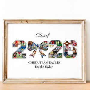 May include: A framed print featuring the text "Class of 2023", "Cheer Team Eagles", and a name. The numbers 2, 0, 2, and 3 are filled with team photos. A bow shape is between the numbers. The frame is a light brown colour.