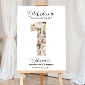 May include: A white sign on an easel with the text "Celebrating The Wonderful Year of" and "Welcome to Olivia Wilson, 1st Birthday November 20, 2025." The number "1" is filled with baby photos.