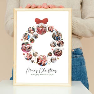 May include: A framed print featuring a Christmas wreath design composed of circular photo collages. A red bow adorns the top. The words "Merry Christmas & Happy New Year 2026" are written in elegant script below the wreath.