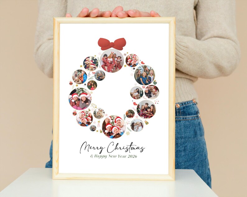 May include: A framed print featuring a Christmas wreath design composed of circular photo collages. A red bow adorns the top. The words "Merry Christmas & Happy New Year 2026" are written in elegant script below the wreath.