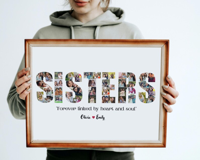 May include: A framed photo collage with the word "SISTERS" spelled out using photos of people. The text below the collage reads "Forever linked by heart and soul" and includes the names "Olivia" and "Emily".