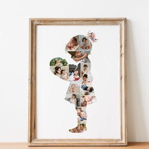 May include: A framed print featuring a silhouette of a child holding a heart-shaped collage. The collage is composed of multiple baby photos in various poses. The frame is a light brown color, and the background is white.
