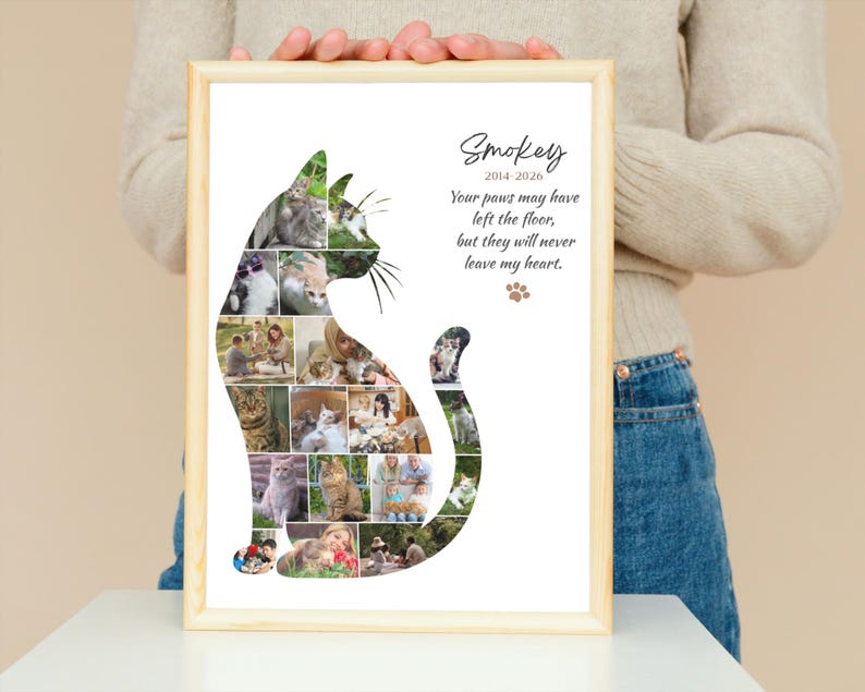 May include: A framed wall art print featuring a collage of various cat photographs arranged into the silhouette of a sitting cat. The text reads Smokey 2014-2026, Your paws may have left the floor, but they will never leave my heart, with a paw print.