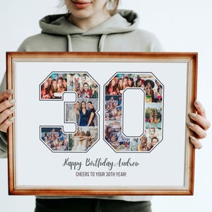 May include: A framed photo collage in a brown frame with a white background. The collage is shaped like the number 30 and is made up of photos of people. The text "Happy Birthday Andrew" and "Cheers to your 30th year!" is printed below the collage.