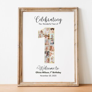 May include: A framed print with a wooden frame. The print features the text "Celebrating The Wonderful Year of" above a collage of photos in the shape of the number one. Below the number one is the text "Welcome to Olivia Wilson, 1st Birthday November 20, 2025."