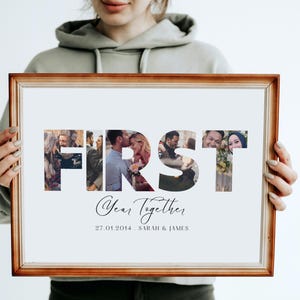 May include: A framed print with the word "FIRST" spelled out in large letters. Each letter is filled with a different photo of a couple. The text "Year Together" and the date "27.01.2014" are below the letters. The text "SARAH & JAMES" is below the date.