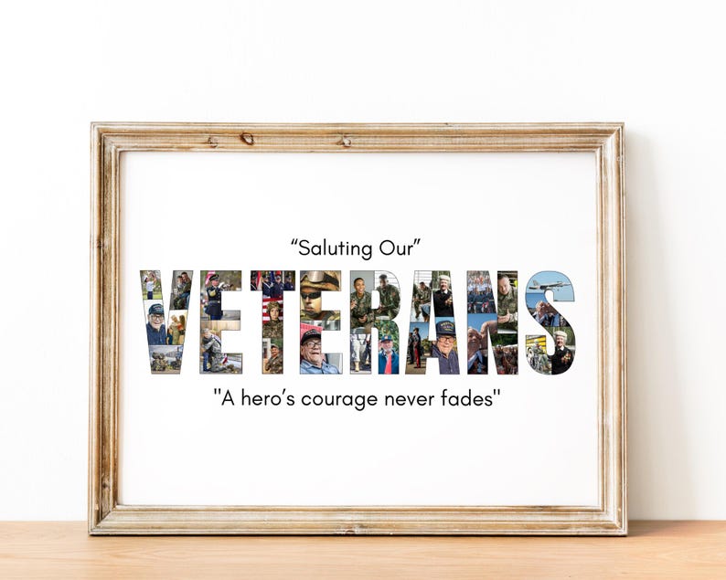 May include: A framed print featuring the word "VETERANS" composed of various photographs. The text "Saluting Our" is above, and "A hero's courage never fades" is below. The frame is a light brown colour.