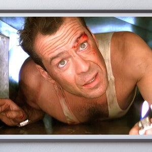 May include: A man with a bloody face is crawling through a tight space. He is holding a lighter in his right hand and the flame is visible.