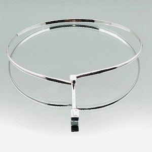 May include: A silver choker necklace with a simple, geometric pendant. The necklace is made of two thin bands of metal that meet at the pendant.