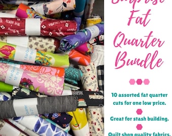 May include: A bundle of assorted fat quarter fabric cuts, featuring various patterns and colors. The image includes rolls of fabric with floral, geometric, and Canadian-themed designs. Text on the image reads "Surprise Fat Quarter Bundle".