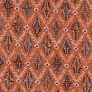 May include: A seamless pattern featuring a repeating design of stylised leaves and flowers in shades of brown and pink on a rust-coloured background.