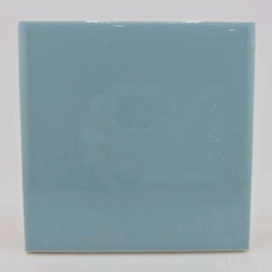 May include: A square, light blue ceramic tile with a glossy finish. The tile is a solid color and appears to be new. The edges are clean and sharp. The tile is likely for use in a kitchen or bathroom.