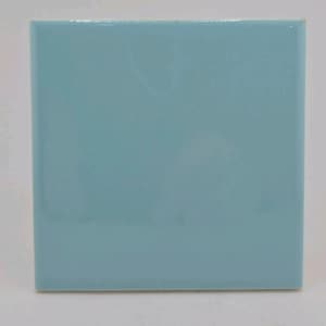 May include: A square, light blue ceramic tile with a glossy finish. The tile is a solid color, with a smooth, reflective surface. The edges are clean and straight. This tile is suitable for home decor and renovation projects.