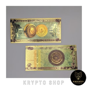 Peut inclure: Deux billets de banque de couleur or avec le mot "Bitcoin" imprimé dessus. Les billets présentent une image stylisée d'une pièce d'or avec le numéro "1" dessus.