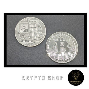 May include: Two silver-colored Bitcoin coins. One coin features a circuit board design with a pickaxe and a small Bitcoin symbol. The other coin features the Bitcoin symbol in the center with the text "Digital Decentralized Peer to Peer" around the edge.