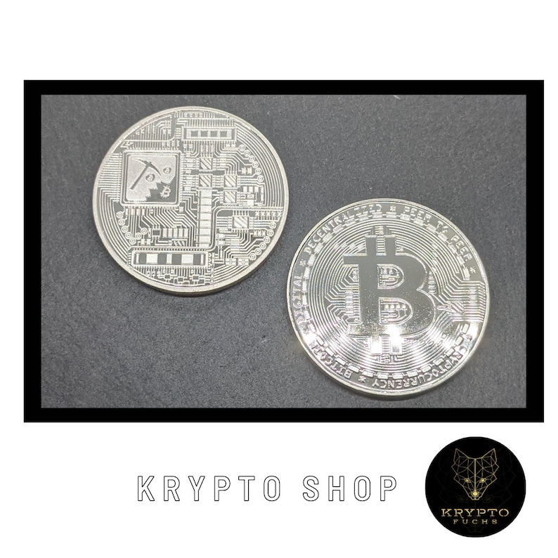 May include: Two silver-colored Bitcoin coins. One coin features a circuit board design with a pickaxe and a small Bitcoin symbol. The other coin features the Bitcoin symbol in the center with the text "Digital Decentralized Peer to Peer" around the edge.