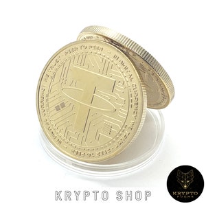 May include: Gold-colored coin with the Tether logo and the inscription "IN DIGITAL CURRENCY WE TRUST, PEER TO PEER." The coin is displayed on a clear plastic holder. The text "KRYPTO SHOP" is at the bottom.
