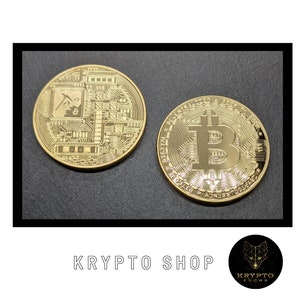 May include: Two gold-colored Bitcoin coins. One coin features a circuit board design with a pickaxe and the text "BTC". The other coin features the Bitcoin symbol and the text "Decentralized Peer to Peer Digital Currency".