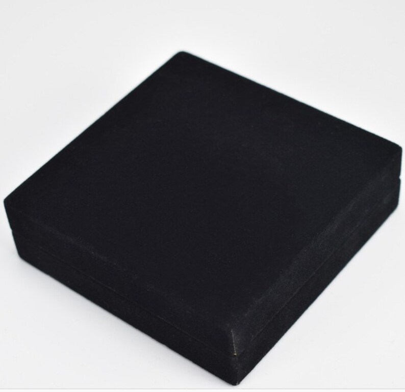 May include: A black velvet jewelry box with a hinged lid.