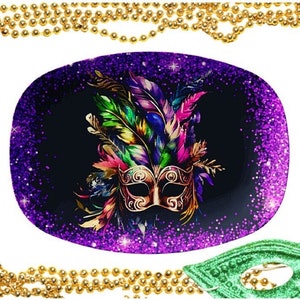 May include: A purple and black oval plate with a gold masquerade mask and colorful feathers. The plate has a glittery finish.
