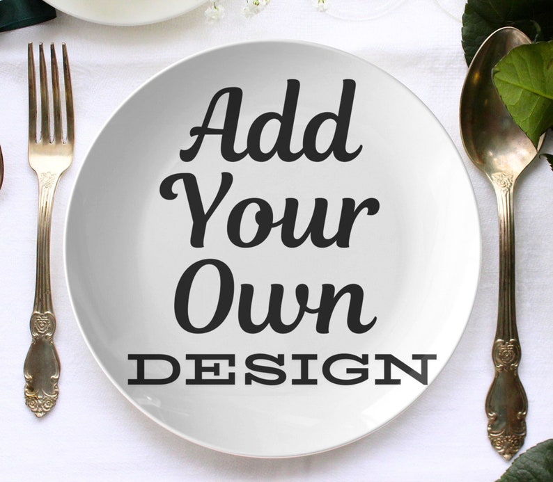 May include: White ceramic dinner plate with the text "Add Your Own DESIGN" in black lettering.