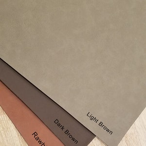 May include: Four leather swatches in different shades of brown. The swatches are labeled "Rawhide", "Dark Brown", "Light Brown", and are arranged from darkest to lightest.