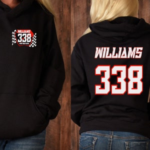 May include: Black hoodie with a white and red racing design on the front and the name "Williams" and the number "338" on the back.