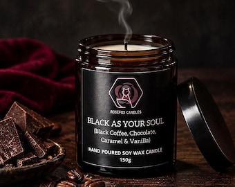 May include: A 150g hand-poured soy wax candle in a brown glass jar with a black label reading ROSEFOX CANDLES, BLACK AS YOUR SOUL, Black Coffee, Chocolate, Caramel & Vanilla. A thin wisp of smoke rises from the lit wick above the jar.