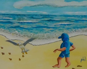 Boy chasing bird on the beach