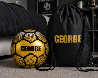 May include: A personalized soccer ball and drawstring bag. The soccer ball is gold with black geometric patterns and the name "GEORGE" in black. The black drawstring bag also features the name "GEORGE" in gold.