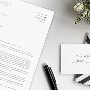 May include: A professional resume template with the name "Eleanor Smart" and the title "Senior Program Manager" is displayed on a white surface. A business card with "Instant Download" text is next to a pen and a small potted plant.