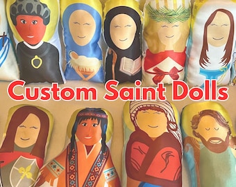 May include: A collection of custom saint dolls, each with unique features and colors. The dolls are made of fabric and have a soft, plush texture. They are perfect for religious education or as gifts for special occasions.