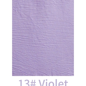 May include: A rectangular swatch of light violet fabric featuring a distinctively crinkled and textured surface. Below the fabric, the text 13# Violet is printed in a matching light purple colour, clearly labelling the specific shade of the material.