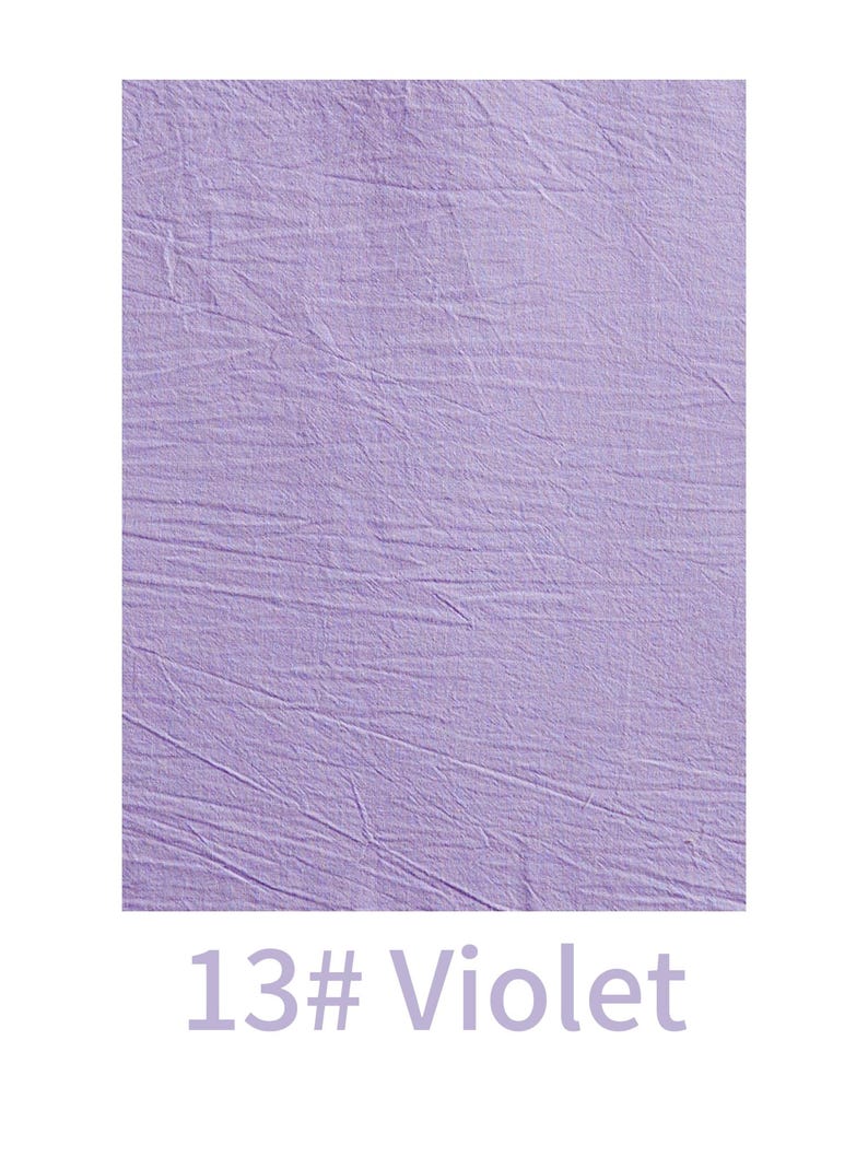 May include: A rectangular swatch of light violet fabric featuring a distinctively crinkled and textured surface. Below the fabric, the text 13# Violet is printed in a matching light purple colour, clearly labelling the specific shade of the material.