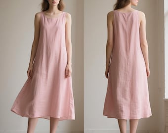 May include: A sleeveless, light pink linen dress. The dress has a simple, round neckline and a flowing, midi-length skirt. The fabric appears to be lightweight and breathable, suitable for warm weather. The dress is shown from the front and back.