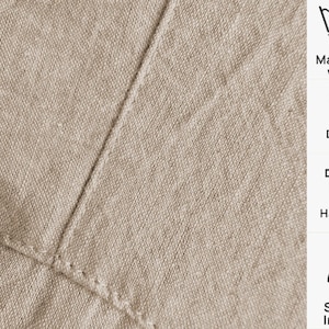 May include: Close-up of beige linen fabric with visible stitching. The image includes care instructions: machine wash at 30 degrees, do not dry, hang to dry, and steam ironing.